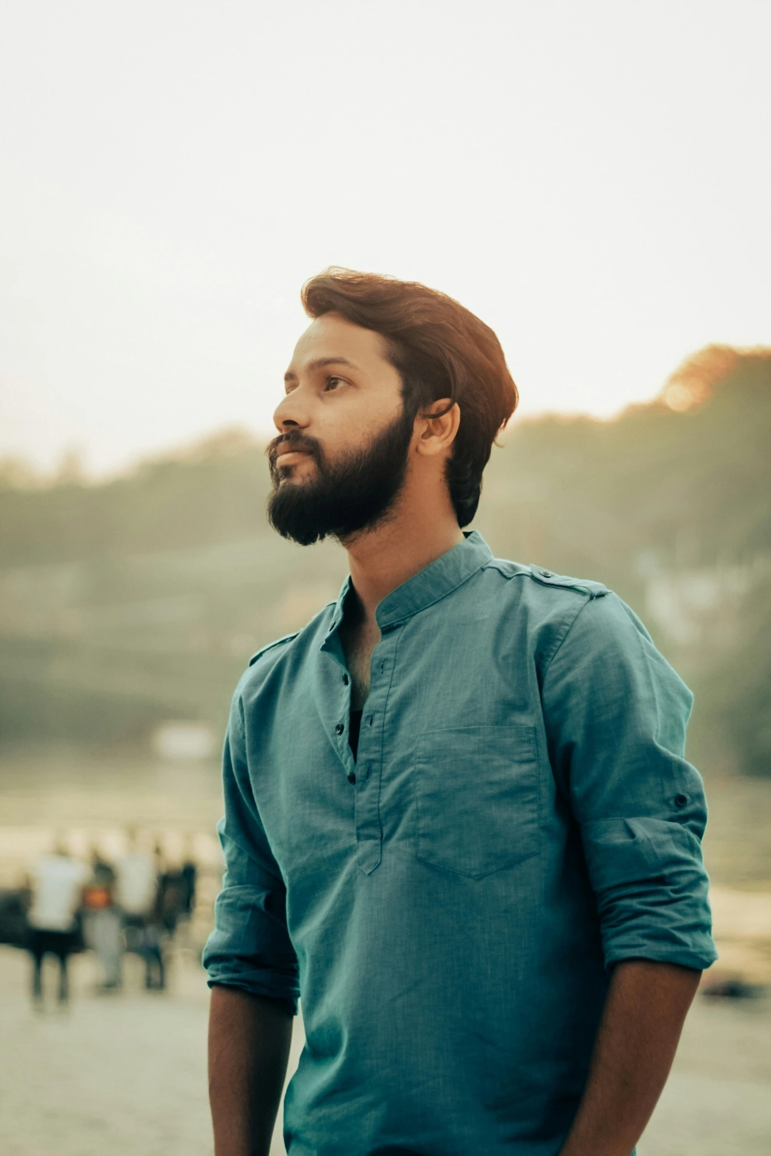 a man looking back while standing next to other people