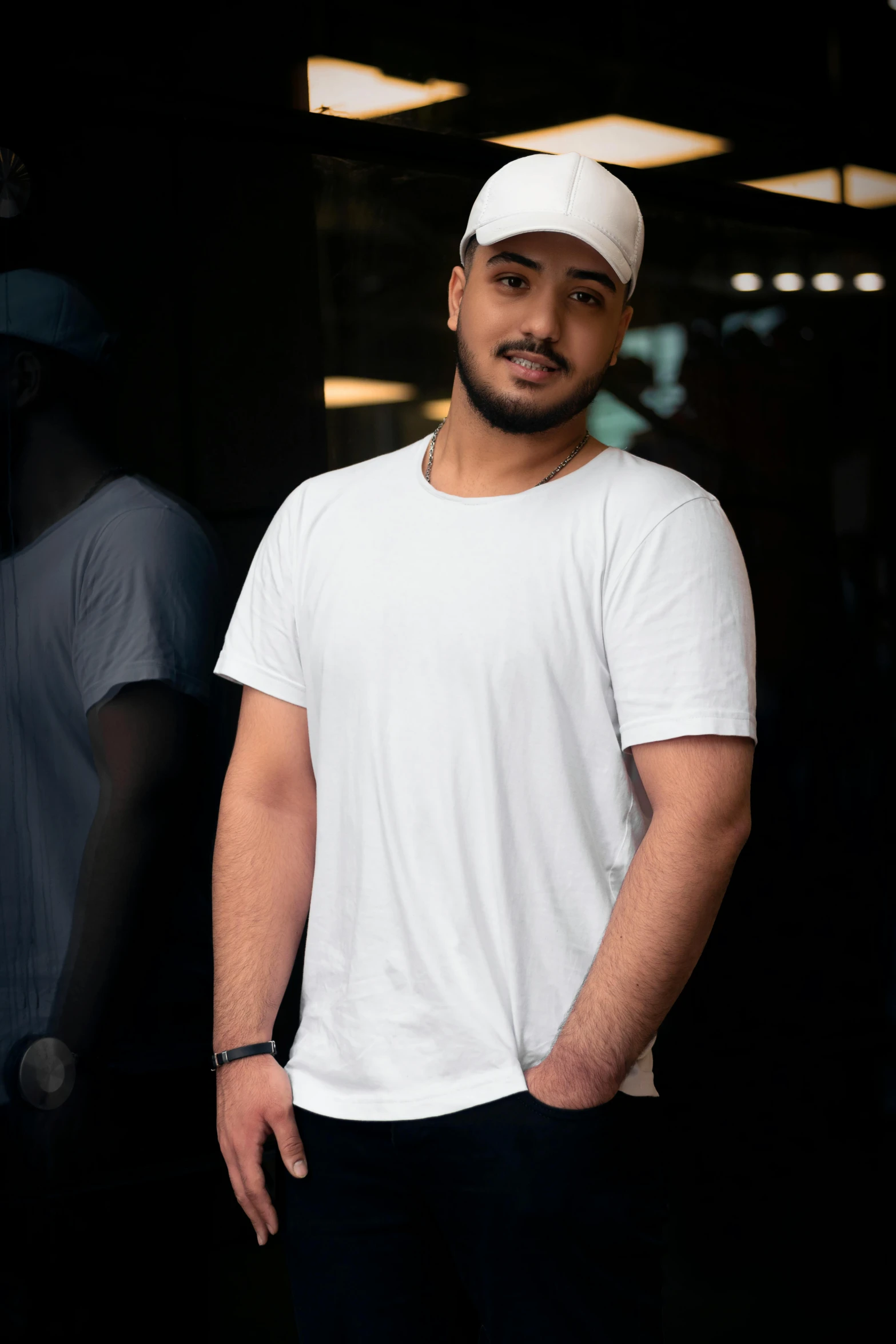 a man in a white shirt and black pants standing in front of a doorway