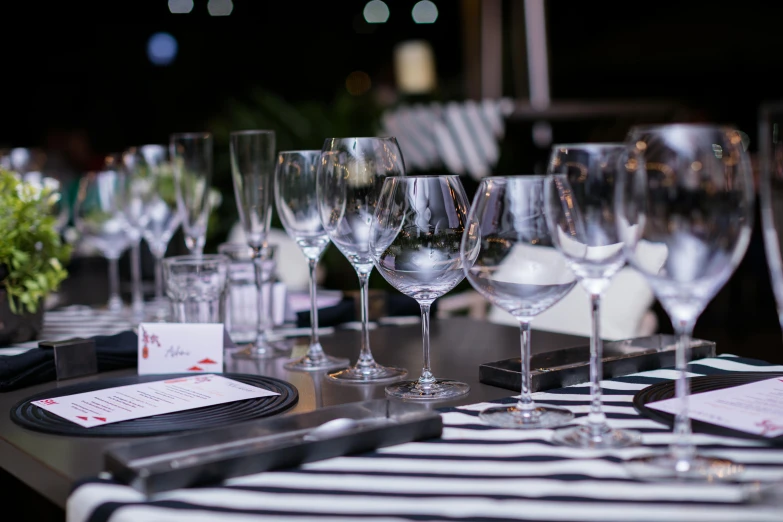 wine glasses lined up on a table for a party