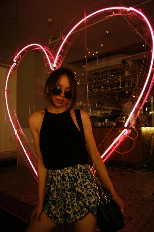 a young lady holding a bag and heart shaped object