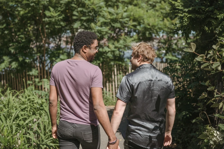 two people walking together in the woods