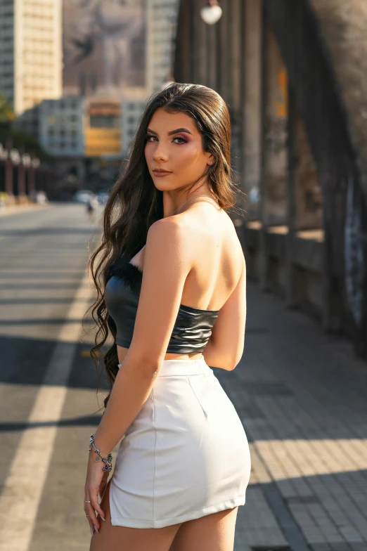 a woman in tight clothes posing on a city street