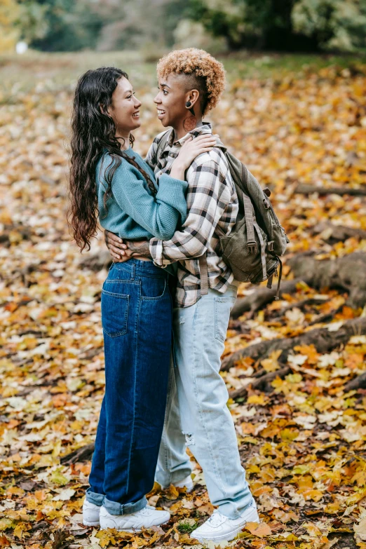 an older couple hugging on the fall leaves