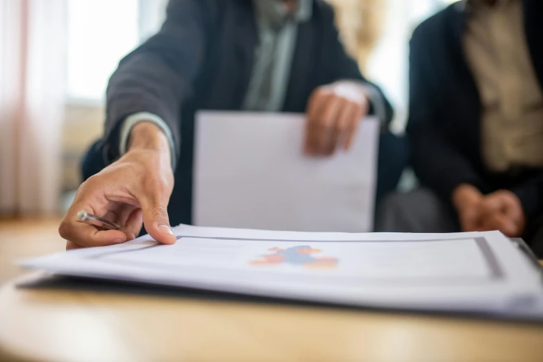 a woman signing into a white book on a table