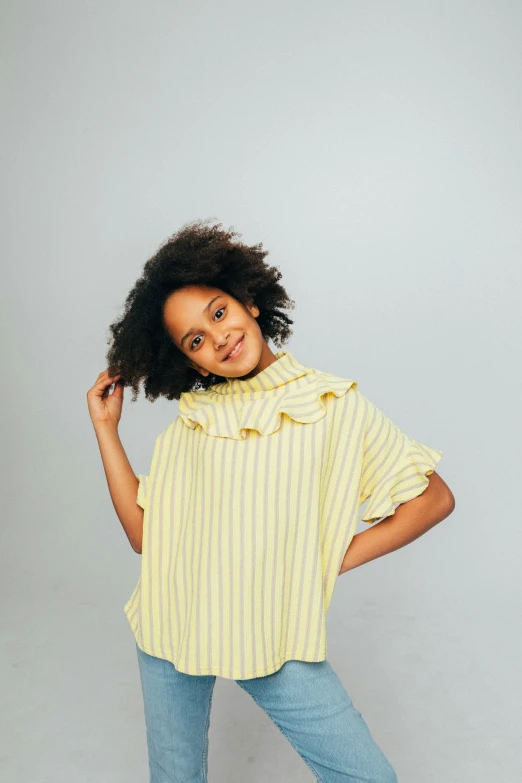 a  posing for a po while wearing a yellow shirt