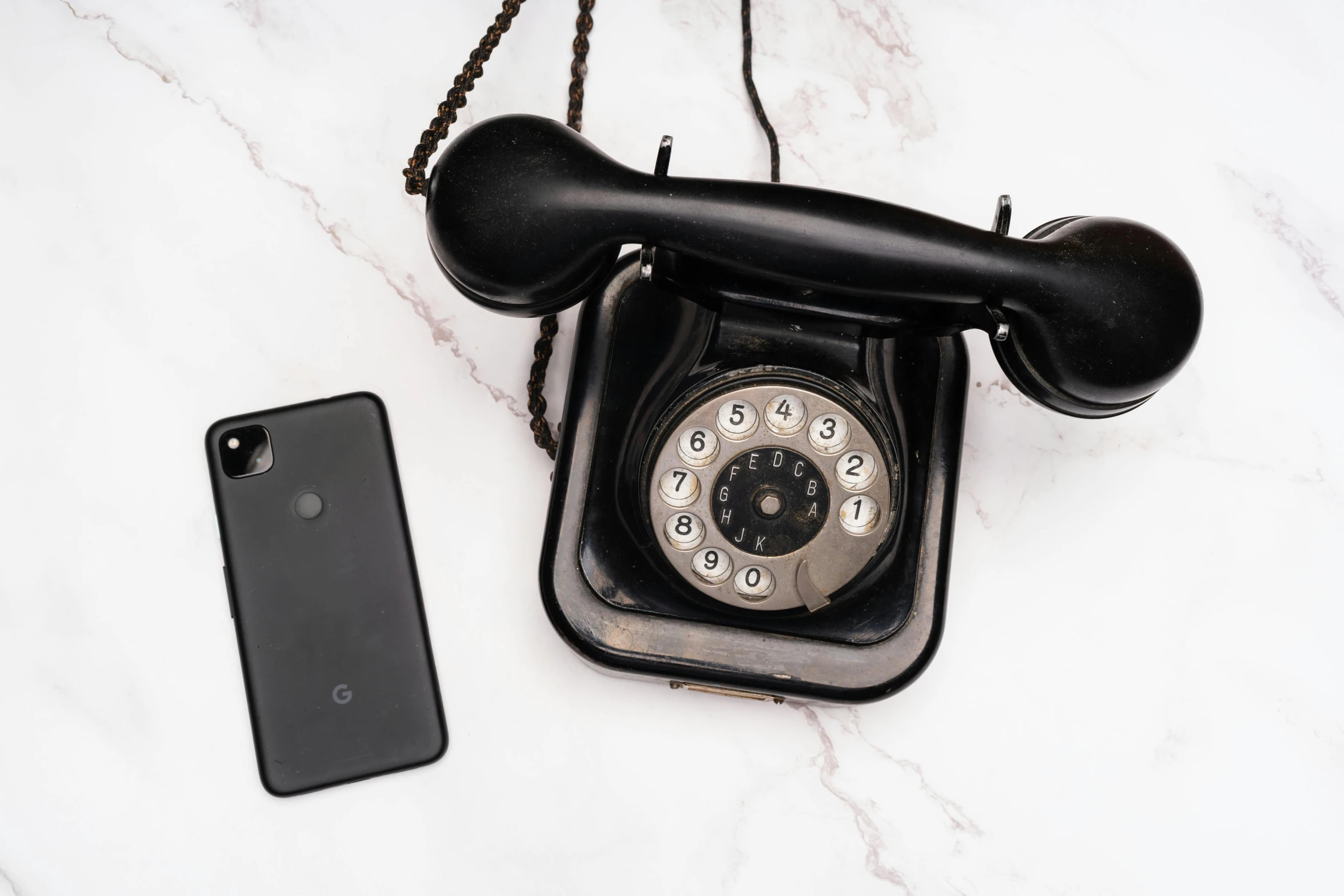 an old fashioned telephone with a phone on top of it