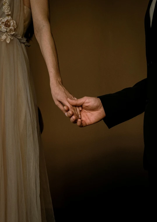 the bride and groom holding hands during a ceremony