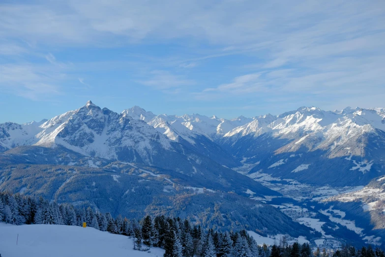 a couple of mountains covered in snow covered ground