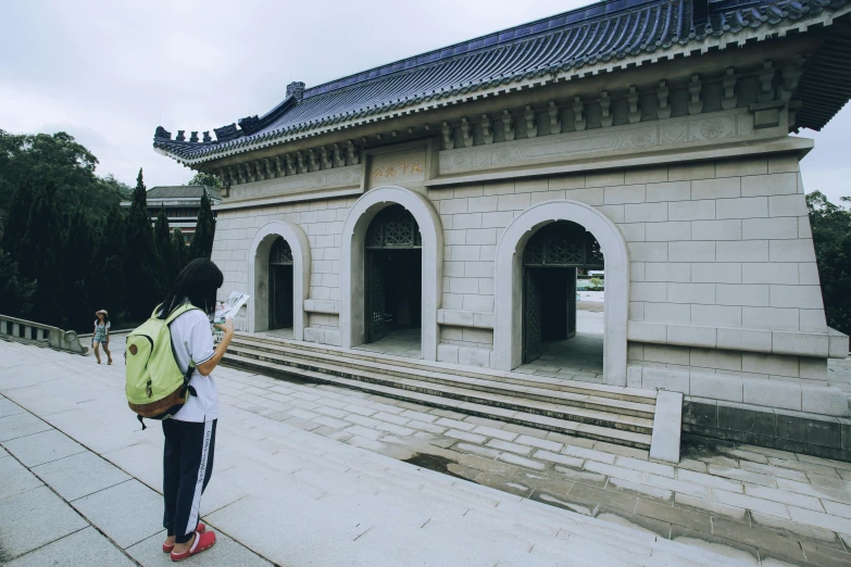 person standing next to the stairs of an outdoor structure