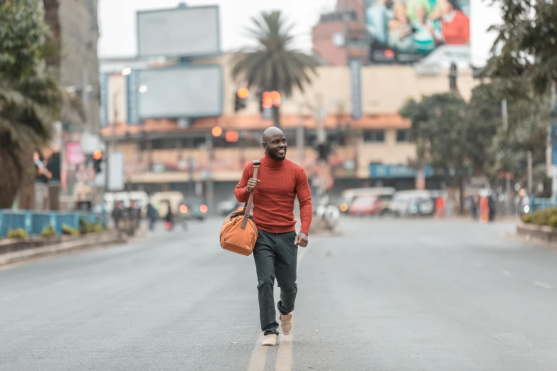 the man is walking down the street carrying bags