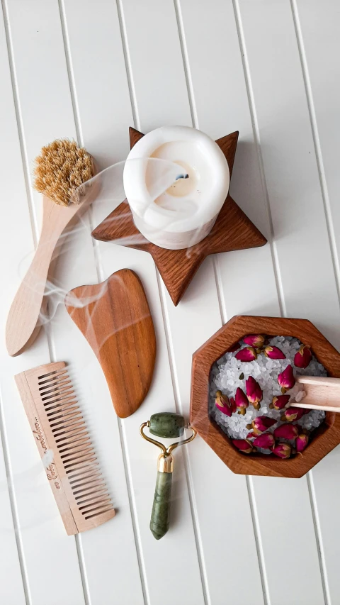 wooden tools such as a comb and shaving brush, flowers and herbs