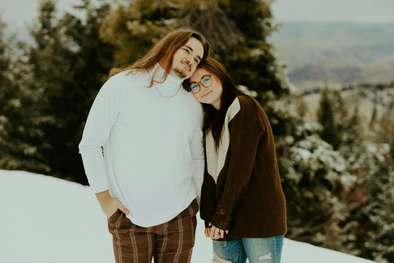 the man and woman are in the snow posing for a picture