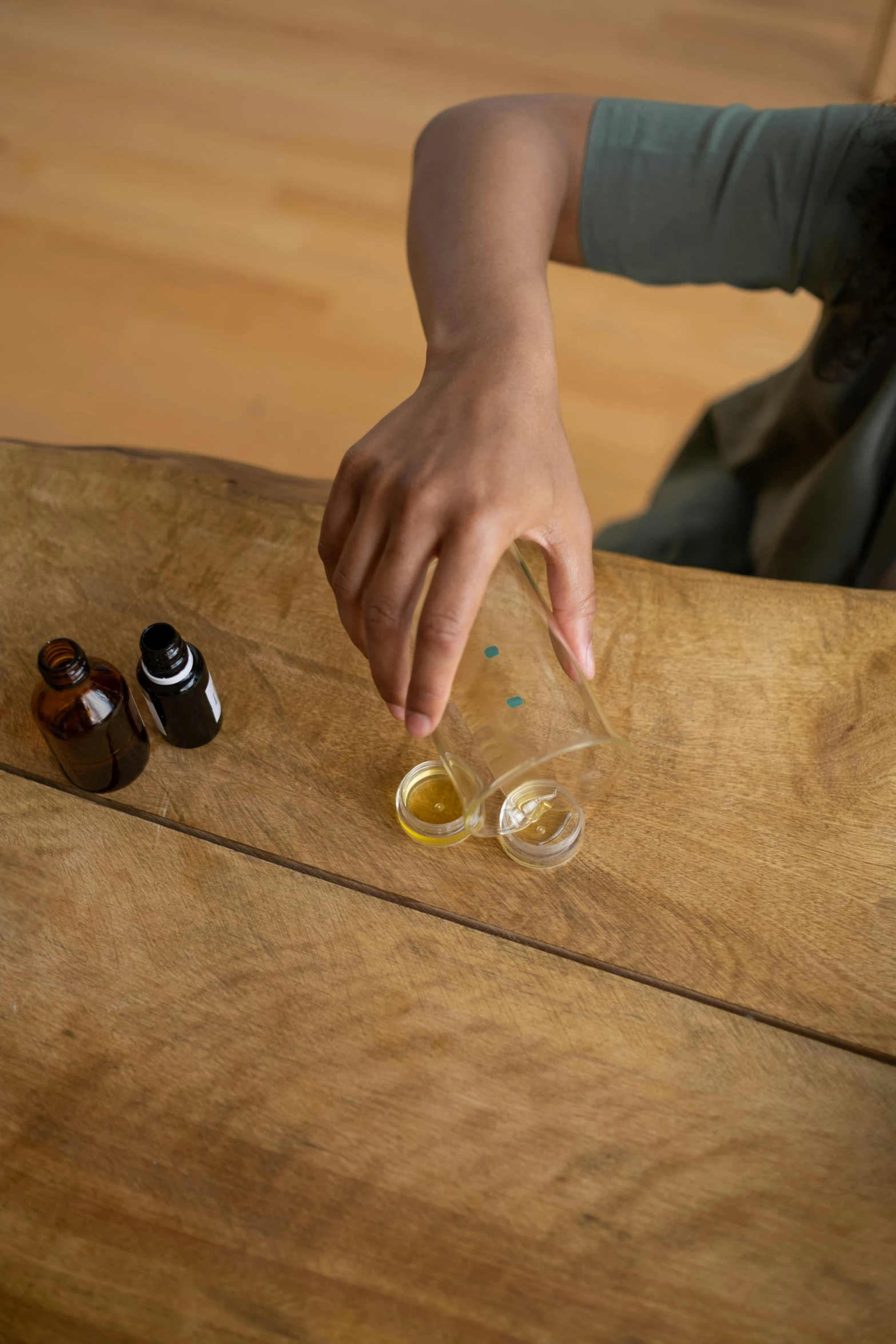 an outstretched woman putting olive oil on to some olives