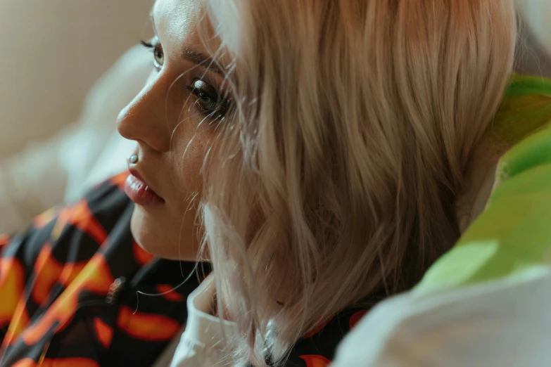 close up of a woman wearing a tie sitting on a couch