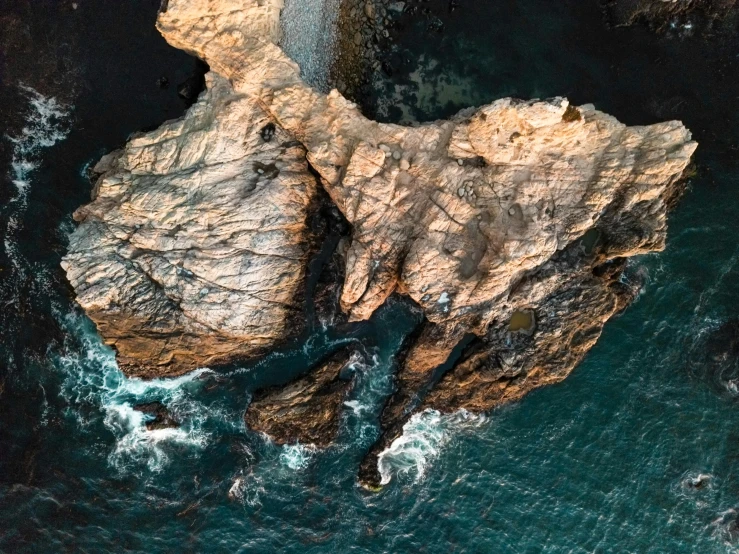 an aerial view of a rocky ocean coastline