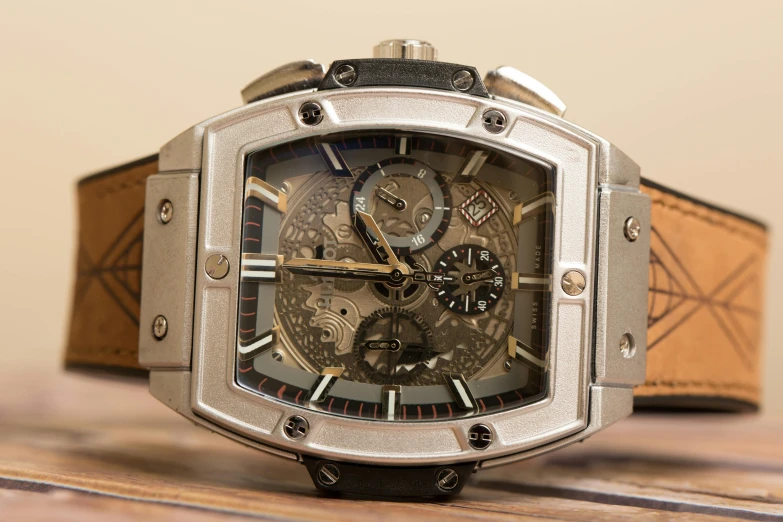 a watch on a wooden table is displayed