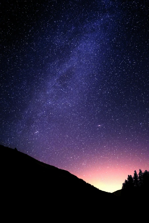 an airplane is flying over a night sky