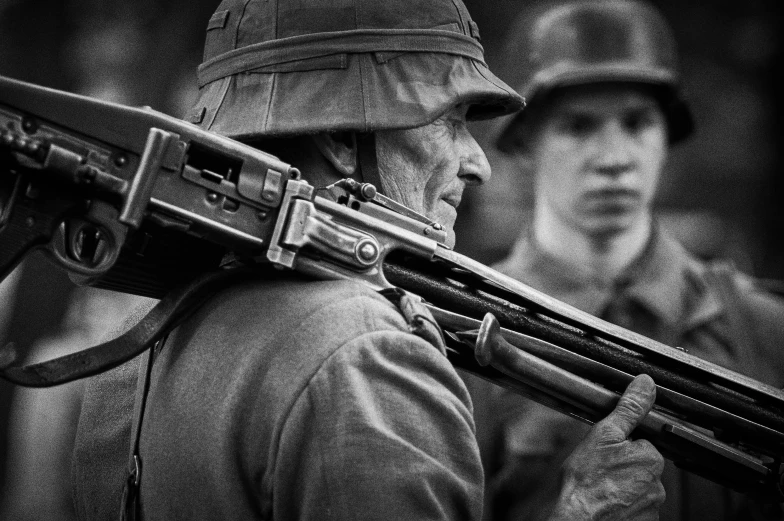 a man wearing a helmet is holding a rifle