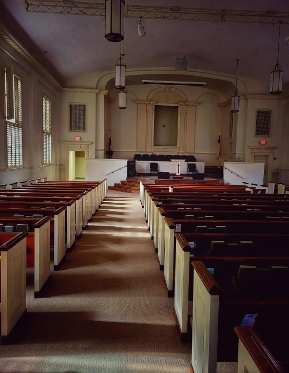 a room full of white pews in a church