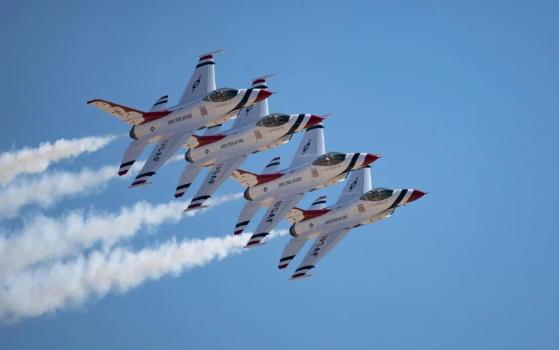 eight jets fly in formation through the sky