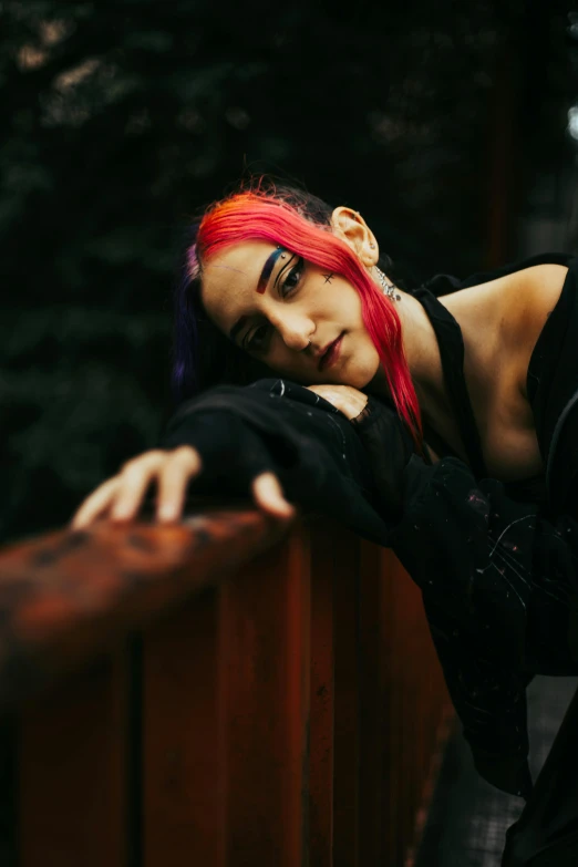 a  with red hair leaning against the railing