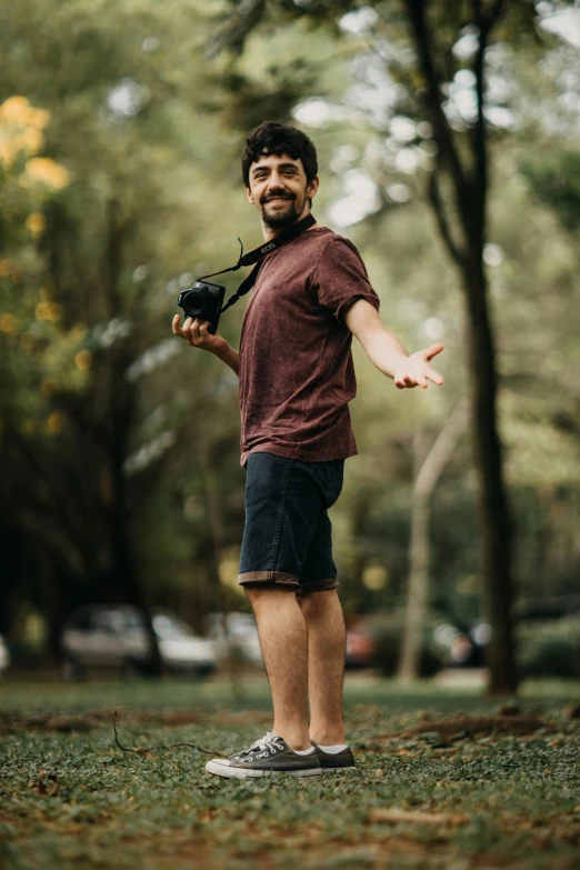 a man holding his camera on top of his shoulder