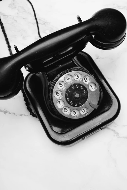 a phone is resting on the marble counter