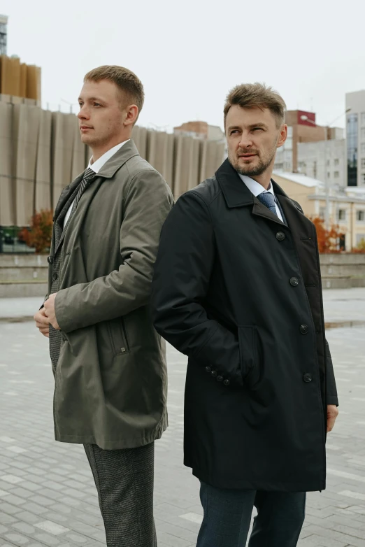 two males standing side by side and staring straight ahead