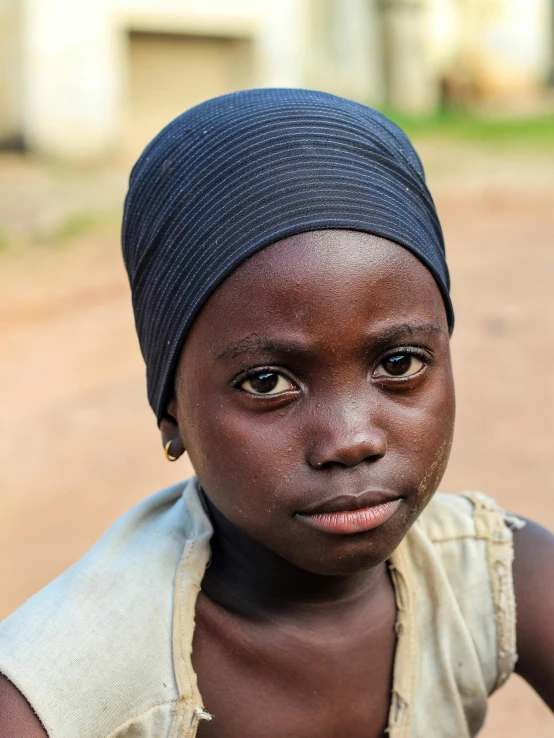 young african girl with a brown shirt and headband