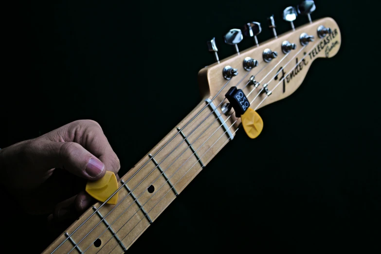 a person holding onto an electric guitar string