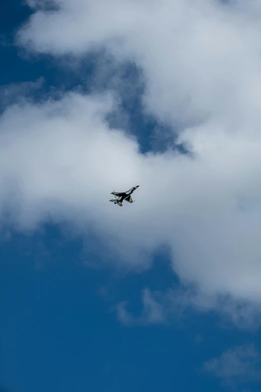 an airplane flying thru the sky during a cloudy day