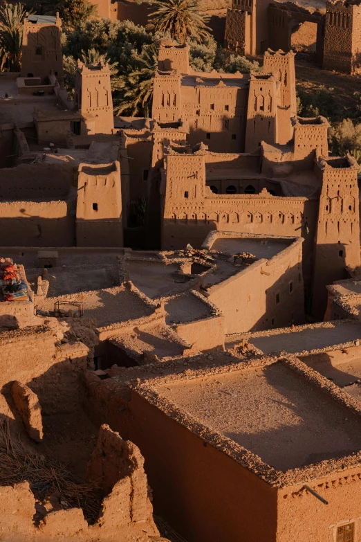 a large group of buildings with sand walls in a desert area