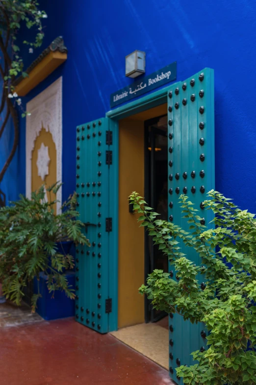 an orange and blue door is in the doorway of a building