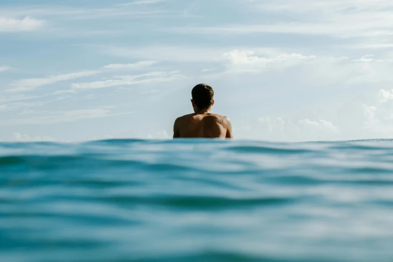 a person is on a surfboard looking out over the water