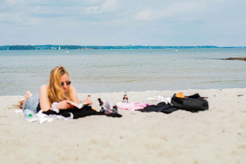 a woman is lounging on the beach