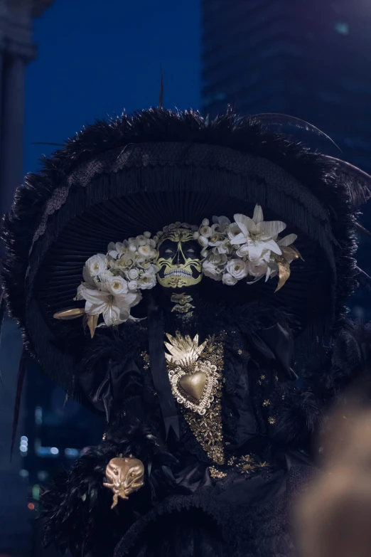 a close up of a hat with flowers and pearls on it