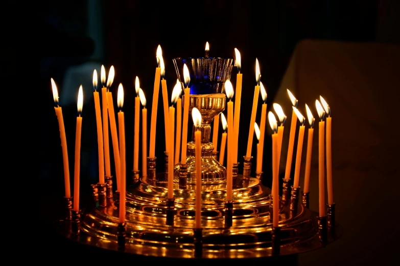 an ornate gold candle stand with white candles