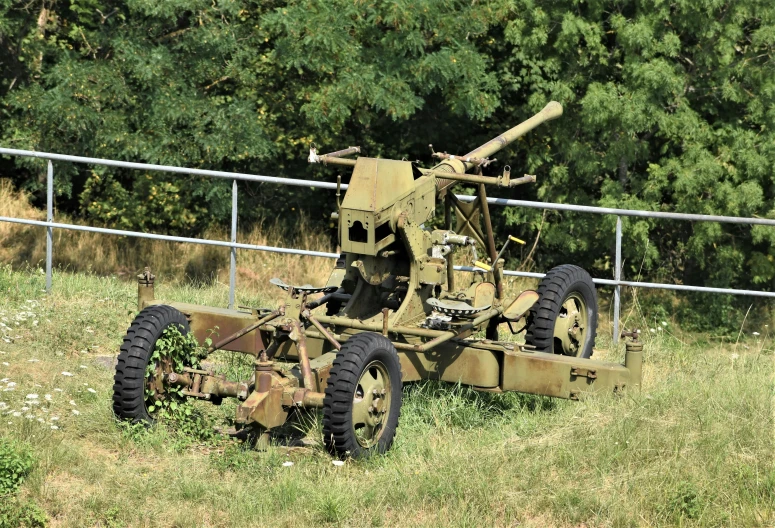 an old military type military machine on grass