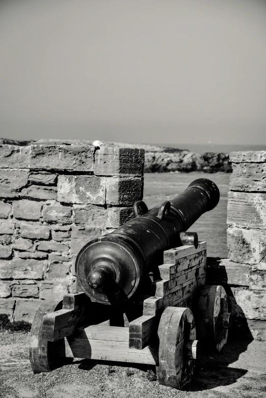 a very old cannon that is next to an old structure