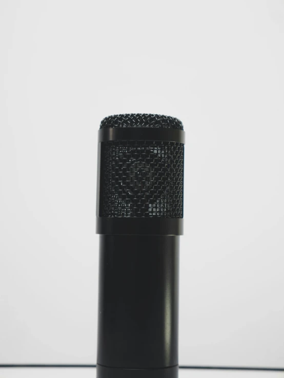 a black microphone on a white surface