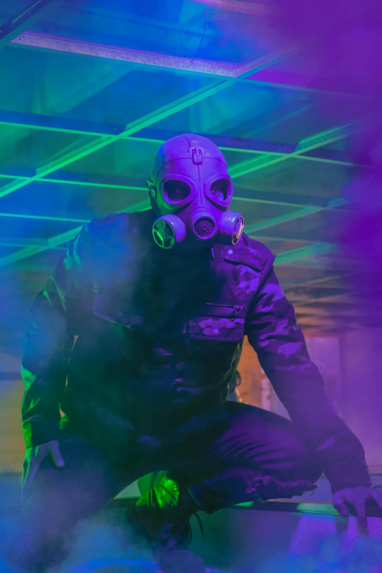 a man in a gas mask sits on a chair