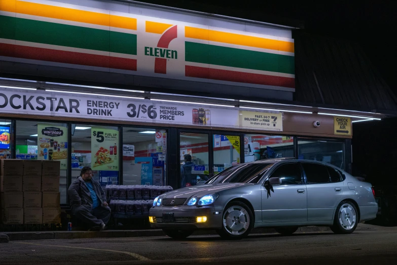 a person is sitting on his car in front of a store