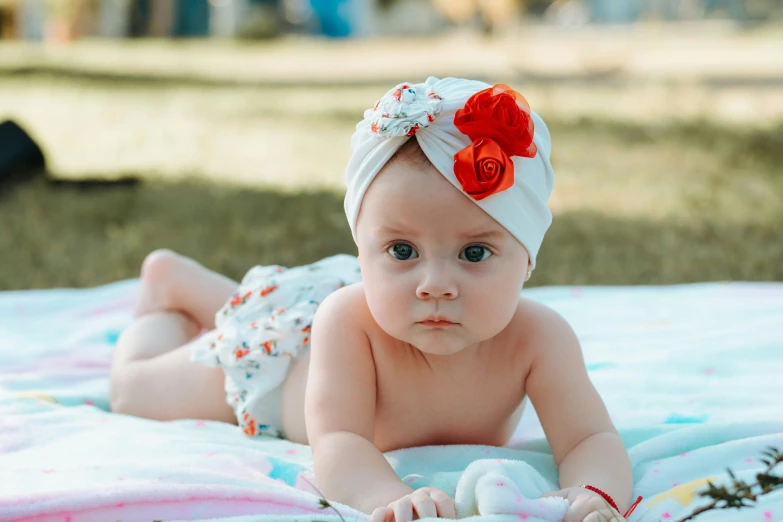 a very cute baby wearing a flower in its hair