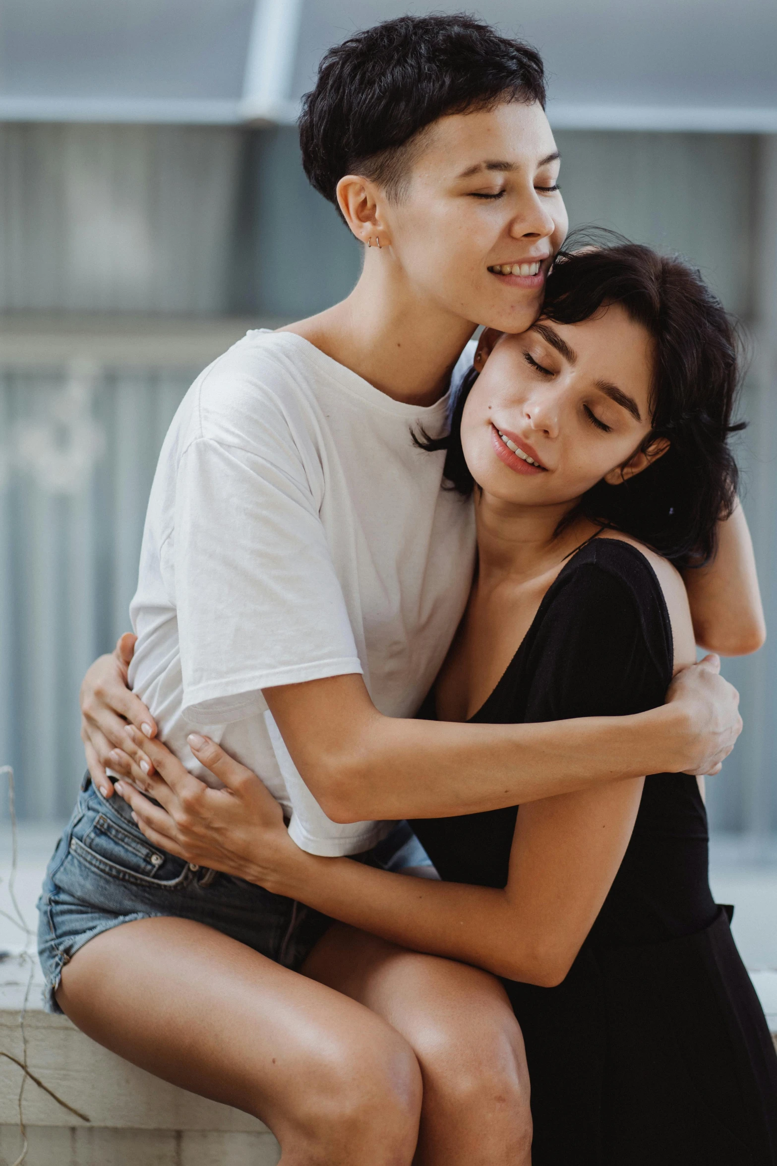 a couple hug each other while sitting together