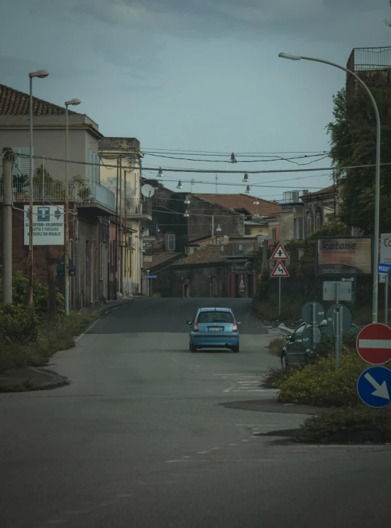 a car drives through an intersection with a street sign