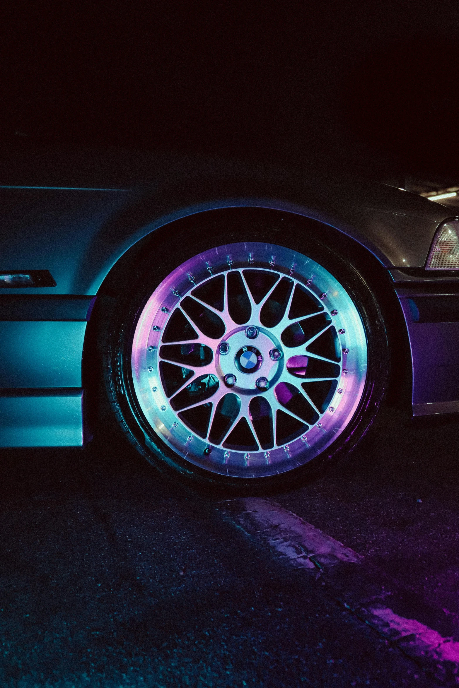 a car's rim with purple lights around it
