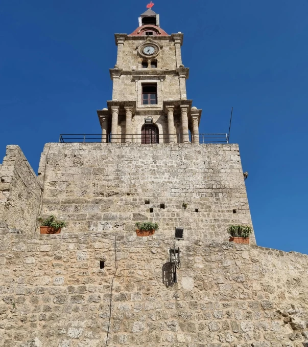 there is a very tall clock tower on the top of the building