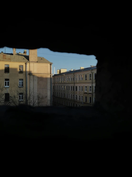 buildings that are next to each other through a dark hole