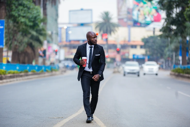 a man walking on the side of the road in business attire