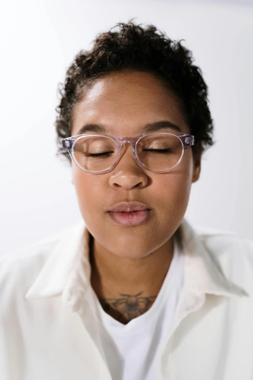 a woman wearing a white shirt and pink glasses